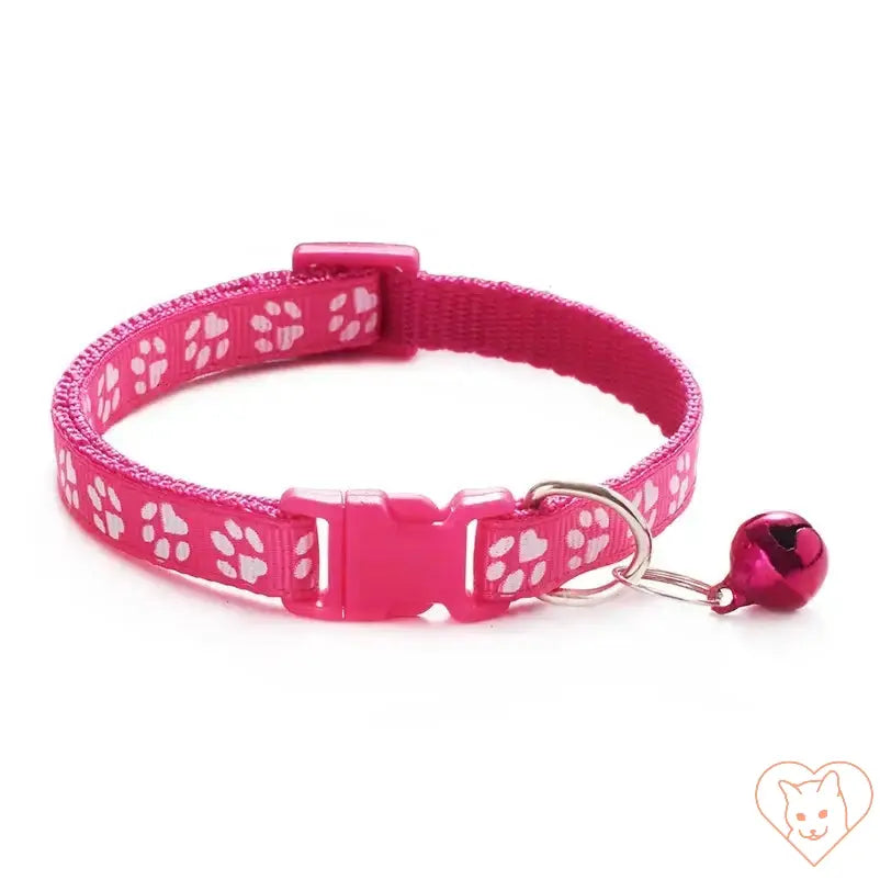 Adjustable pink cat collar with bell and dog print design, perfect for style and safety.