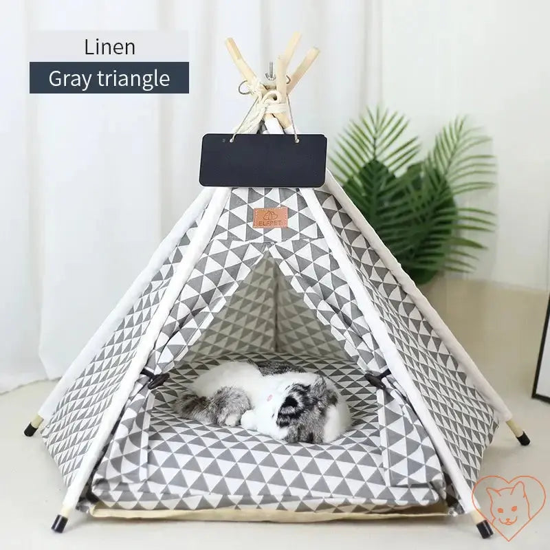 Cozy cat teepee tent in gray triangles with plush cushion, perfect hideaway for cats to relax.