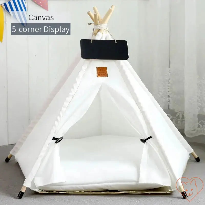 Cozy white canvas cat teepee tent with plush cushion and wooden poles, perfect cat retreat for relaxing.