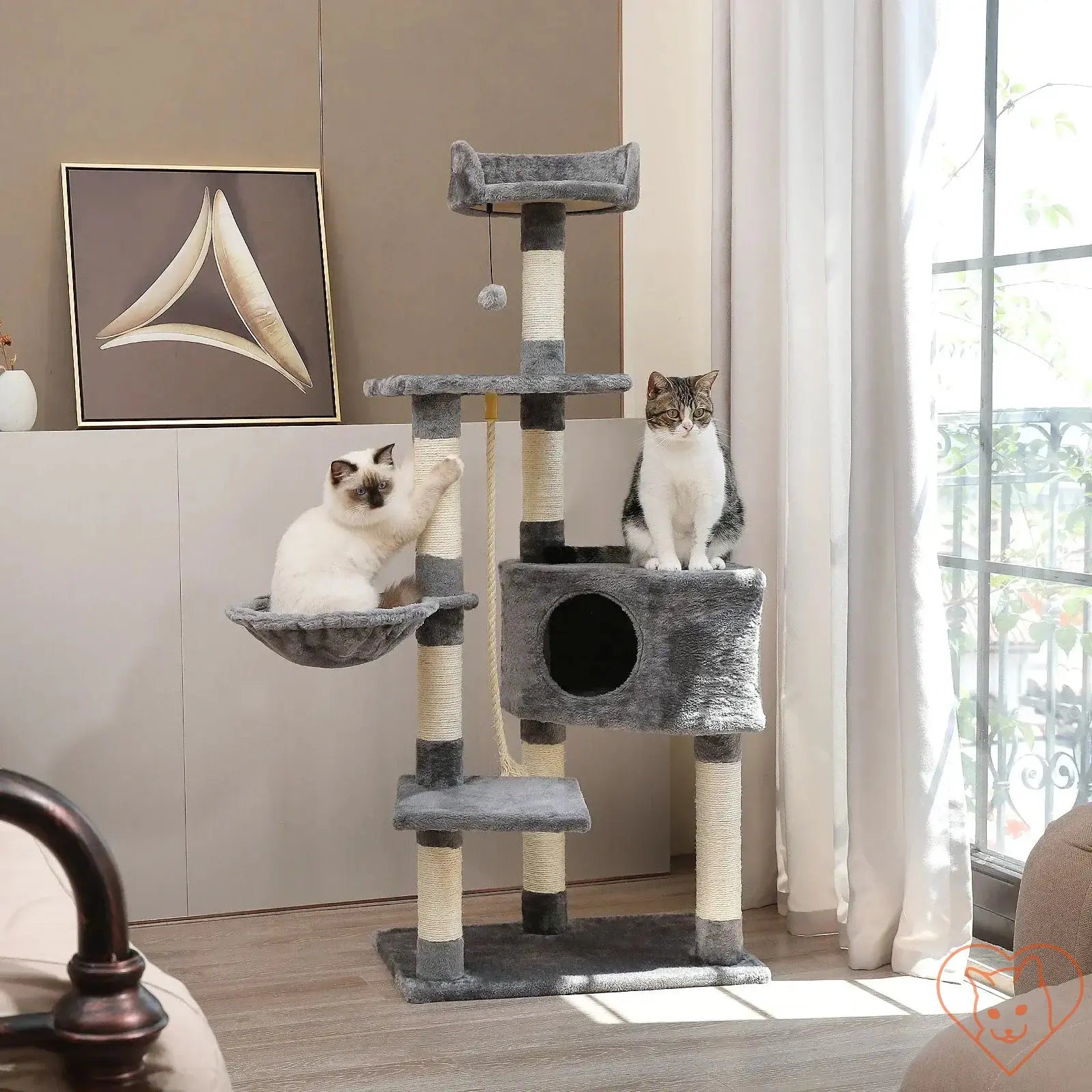 Two cats playing on a 68-inch multi-level cat tree with condos, scratching posts, and a perch in a stylish room.