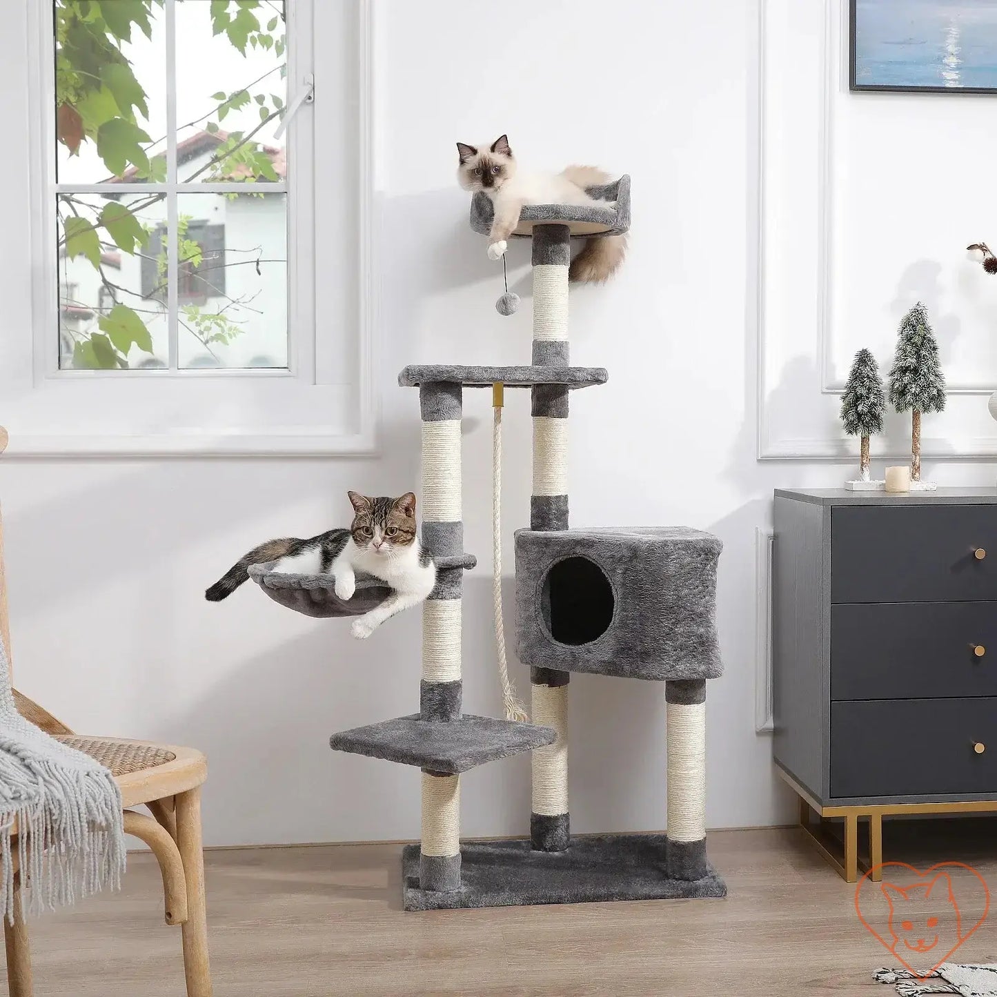 Two cats lounging on a 68-inch multi-level cat tree with condos and sisal posts in a modern living space.