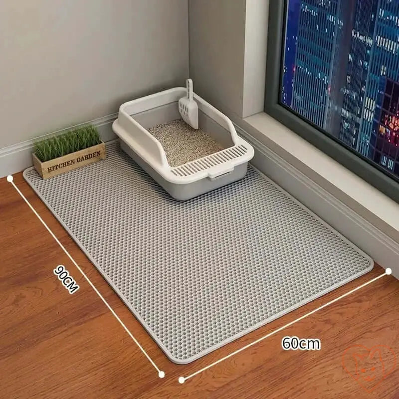 90x60CM cat litter mat with waterproof double-layer, non-slip design for easy cleanup beside a litter box.