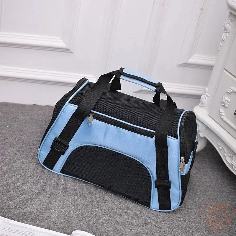 Stylish breathable pet travel bag in blue and black with mesh panels for cats and small dogs.