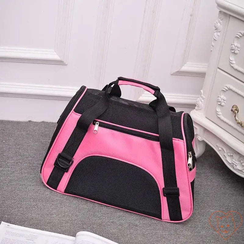 Breathable pink and black pet travel bag designed for cats and small dogs, featuring mesh panels for ventilation.