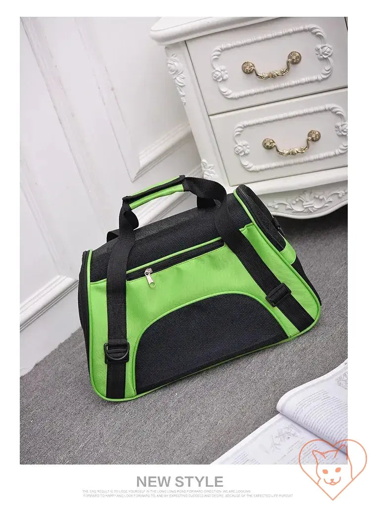 Breathable pet travel bag in black and green, designed for comfort and visibility for cats and small dogs.