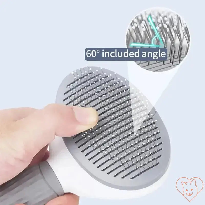 Close-up of cat hair brush showing stainless steel bristles at a 60-degree angle for effective grooming.