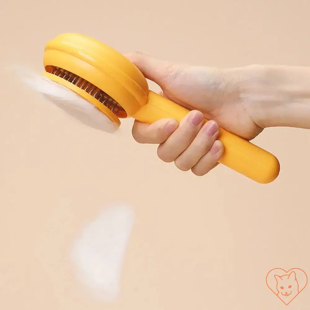 Cat hair removal brush in hand, designed for tangle-free grooming and effective fur removal.