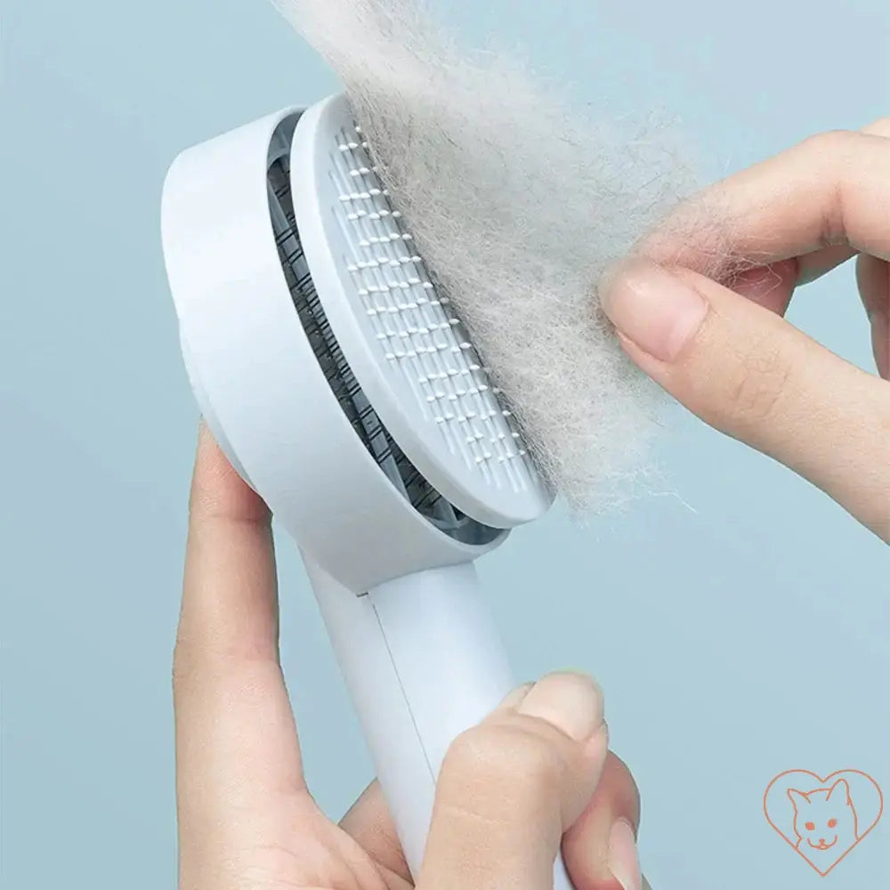 Cat hair removal brush removing loose fur from cat's coat, designed for tangle-free grooming and comfort.