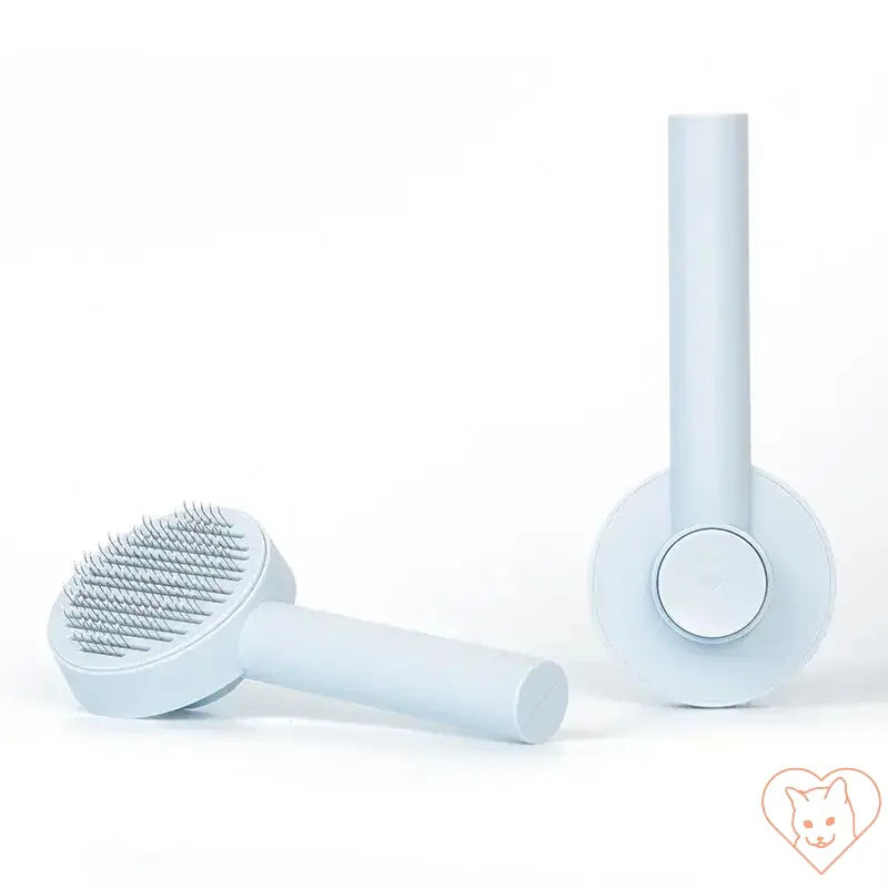 Cat hair removal brush in light blue color for tangle-free grooming and shedding control.