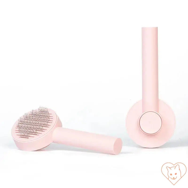 Pink cat hair removal brush for tangle-free grooming and removing loose fur from cats.