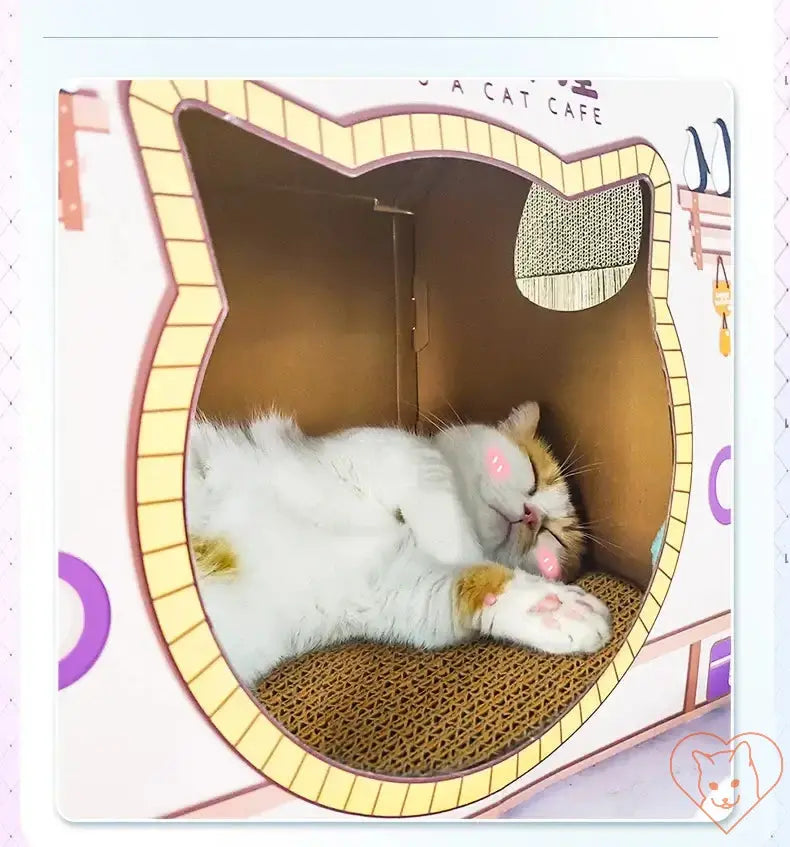 Cozy cat sleeping inside a cat-shaped house with scratching post, showcasing comfort and playfulness.