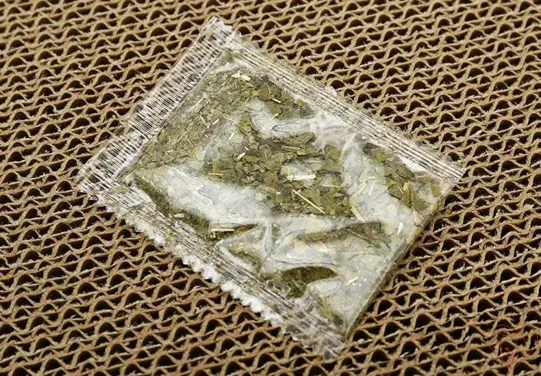 Packaged dried catnip in a clear bag on textured background for feline enrichment and play.