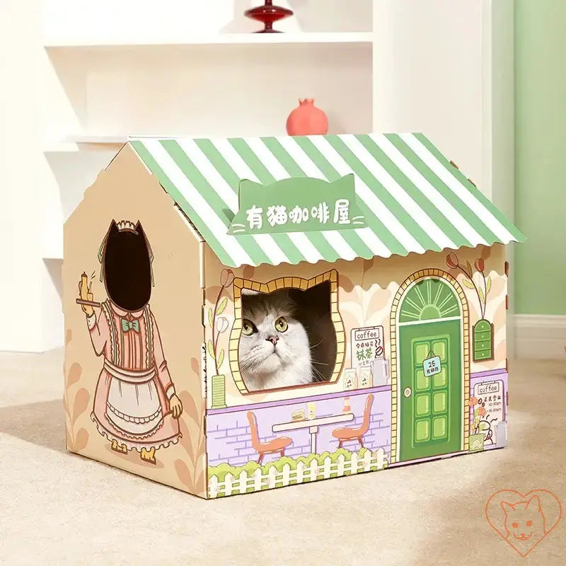 Playful cat peeking out of a colorful cardboard cat house with a café design and striped roof.