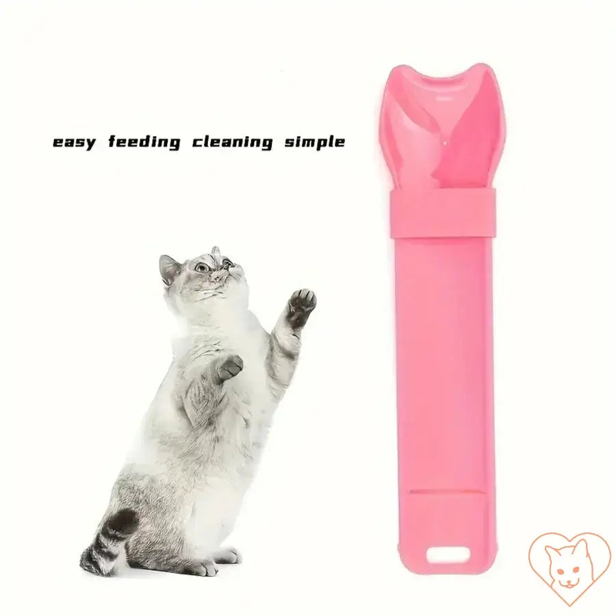 Pink cat strip feeder for lickable treats with playful cat. Easy feeding and cleaning tool for pets.