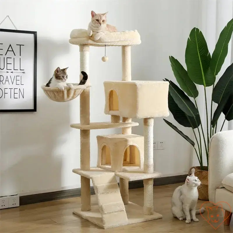 Two cats lounging on a multi-level cat tree house with scratching posts and a hammock in a stylish indoor setting.