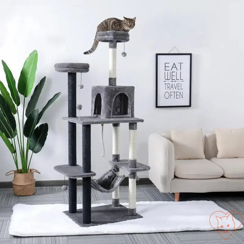 Cat Tree House Tower with scratching posts, multi-level hammock, and a playful cat perched on top.