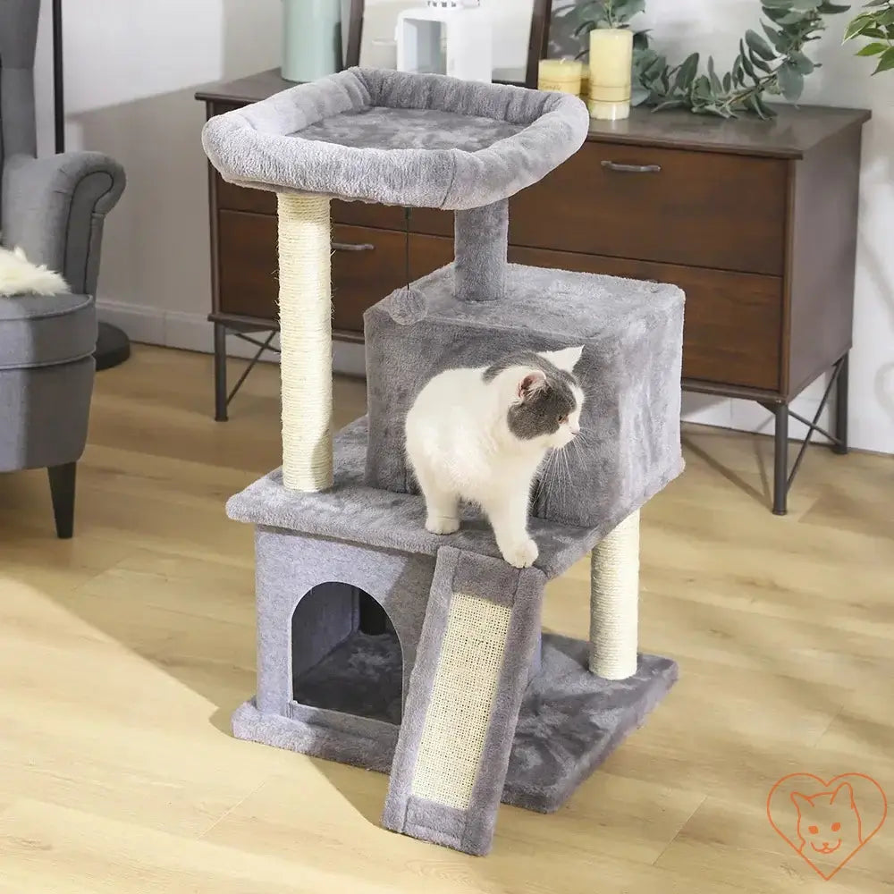 Cat Tree House Tower with multi-level condo, scratching posts, and a playful cat on the structure.