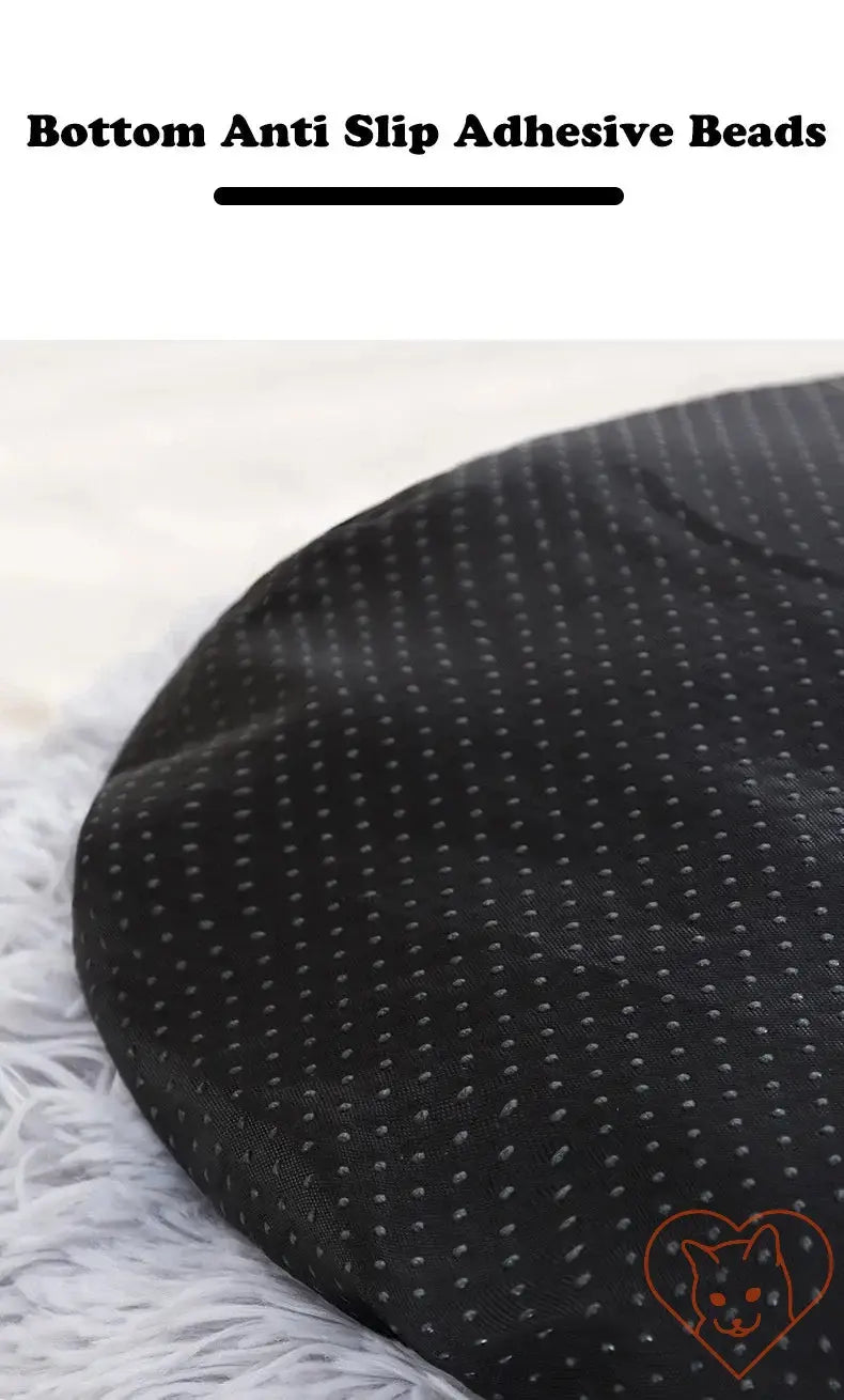 Close-up of circular cat bed's bottom with anti-slip adhesive beads for stability and safety.