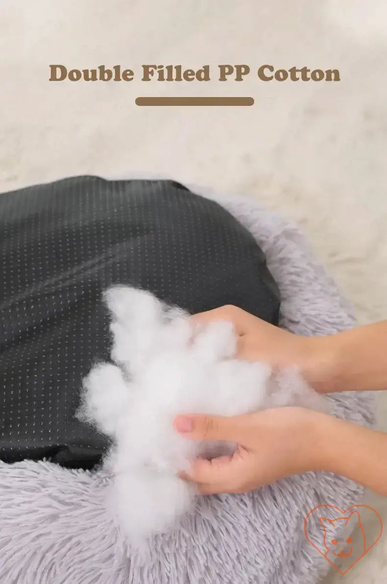Close-up of hands holding double-filled PP cotton for a soft, cozy circular cat bed.