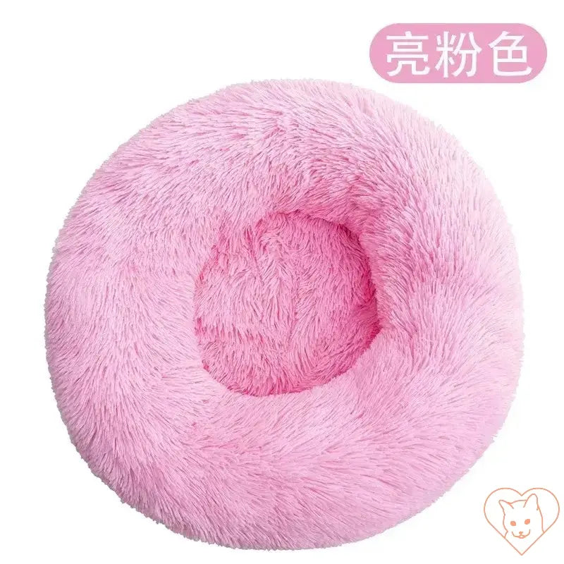 Circular pink cat bed with plush insulation, perfect for providing cozy comfort to your feline friend.