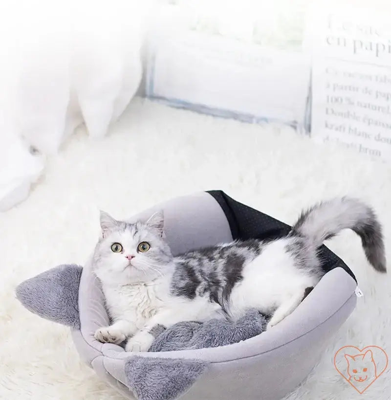 Cozy Winter Cat Cave Bed featuring a cat lounging comfortably inside the plush nest on a soft surface.