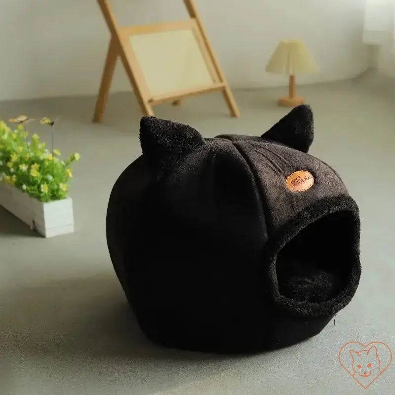 Cozy Winter Cat Cave Bed in black, featuring a soft design with ear details and an entrance for cats and small dogs.