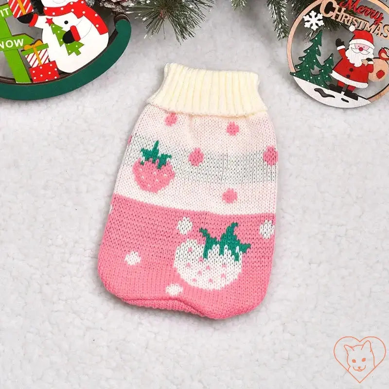 Cute pink cat sweater with strawberry pattern, perfect for keeping cats warm in winter.