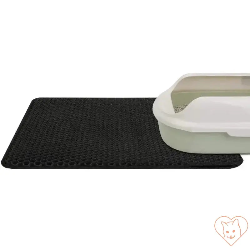 Double-layer waterproof cat litter mat in black next to a cat litter box, designed to trap litter and prevent spills.