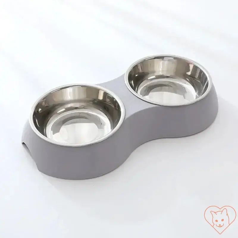 Double stainless steel pet food bowl set with gray plastic base, ideal for dogs and cats, serving food and water.