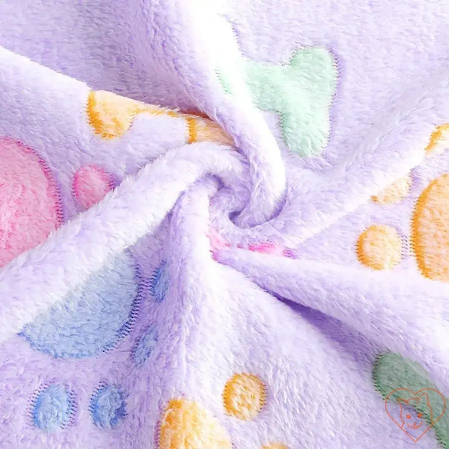 Soft flannel cat blanket with colorful paw print design, ideal for keeping pets cozy and comfortable.