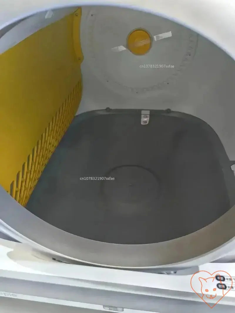 Interior view of a self-cleaning cat litter box with a yellow liner and gray bottom, designed for easy litter management.