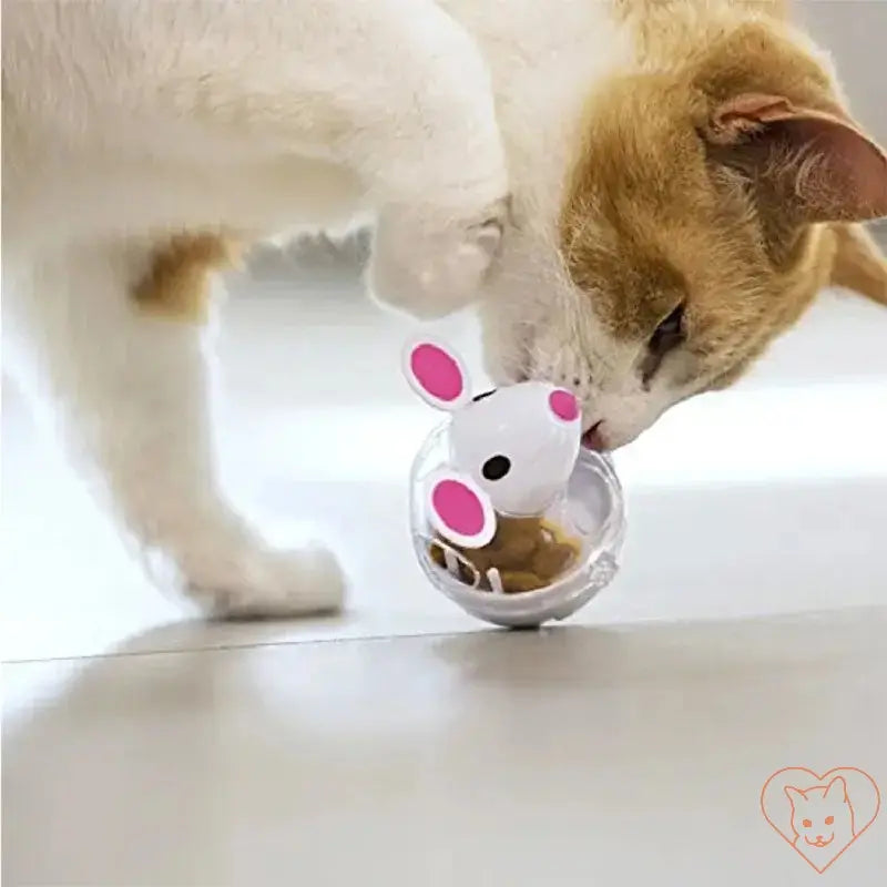 Cat interacting with an interactive treat-dispensing toy shaped like a mouse on the floor.