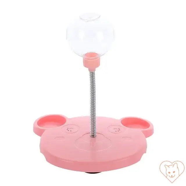 Pink interactive pet feeder toy with a clear ball and suction base for dogs and cats.