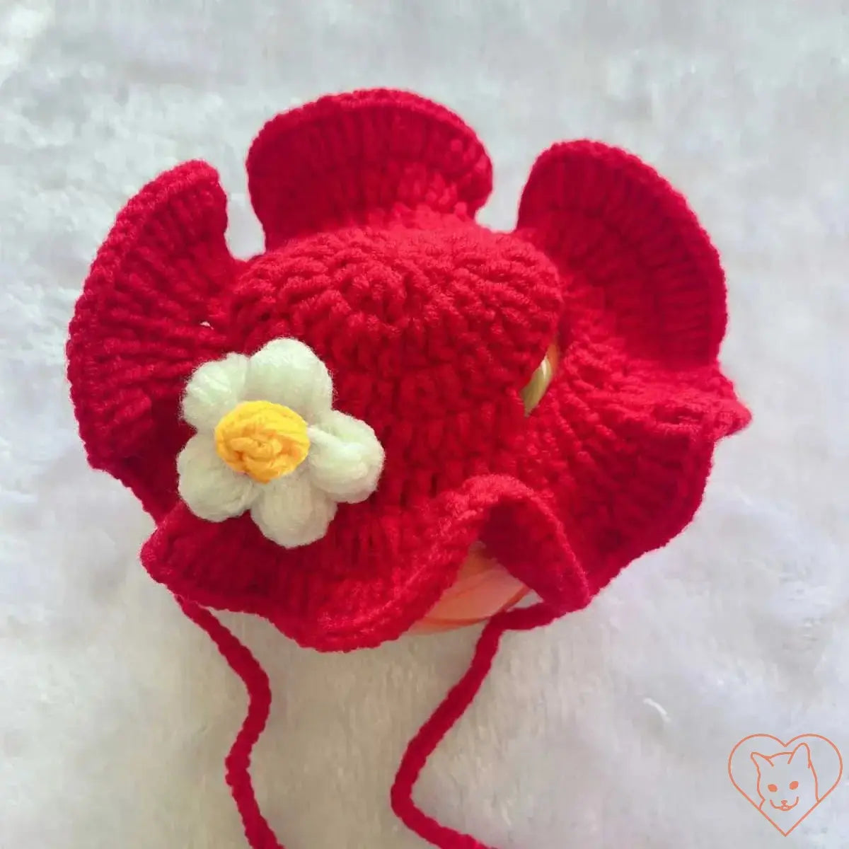 Cozy red knitted cat hat with a flower embellishment, perfect for autumn and winter pet fashion.