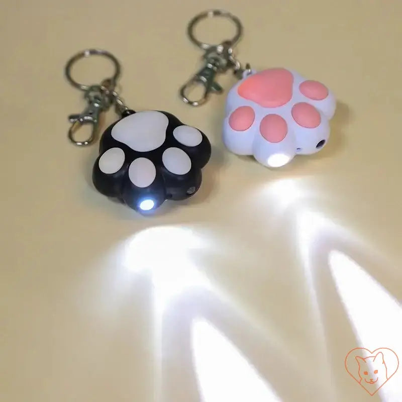 Laser Cat Teaser Keychain featuring cute paw prints and light projections, ideal for playful cat entertainment.