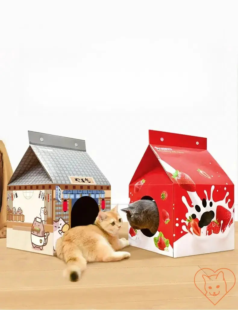 Two milk carton-shaped cat houses with playful designs, featuring a cat lounging beside a red milk carton house.