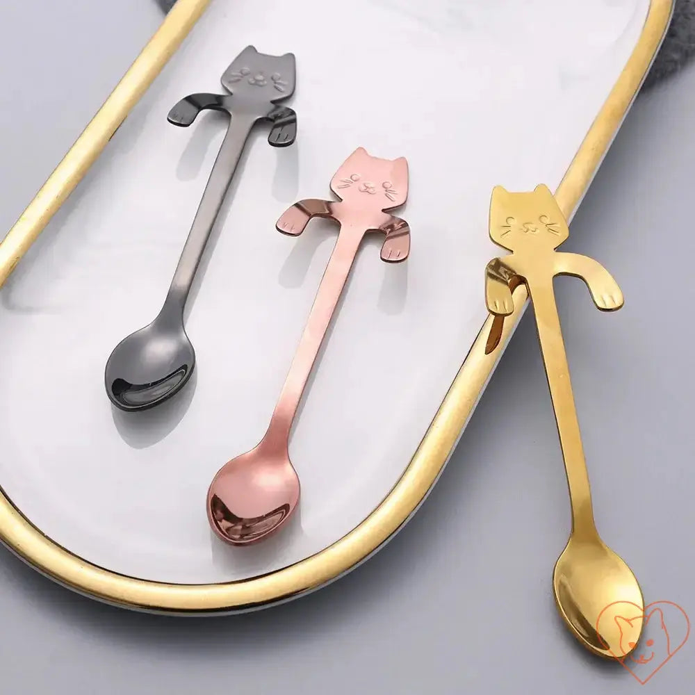 Mini cat coffee spoons in stainless steel, featuring playful cat designs in black, rose gold, and gold on a decorative tray.