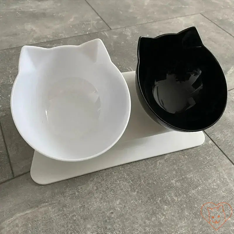 Non-slip double cat bowl with stand, featuring black and white bowls in a 15° tilt design for ergonomic feeding.