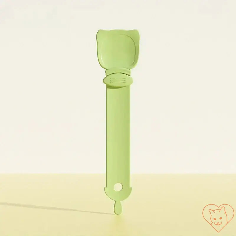 Multifunctional green cat feeding spoon for wet food, designed for easy dispensing of snacks and treats for pets.