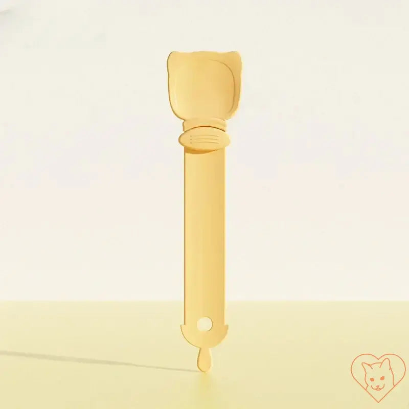 Multifunctional cat feeding spoon in yellow for dispensing wet food and treats for pets, featuring a cute cat-shaped design.