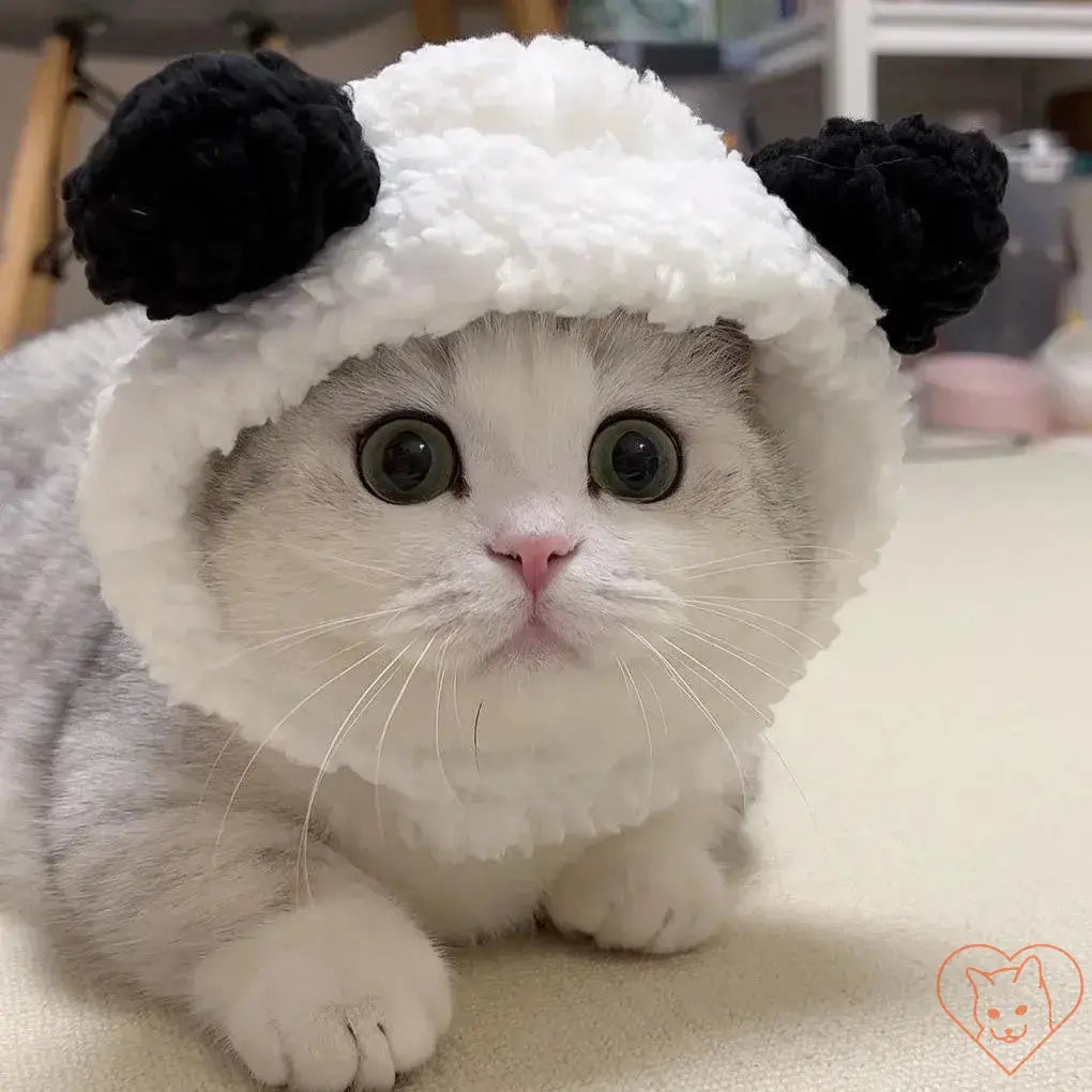 Adorable cat wearing a plush panda headband, showcasing cute features and cozy design for pets.