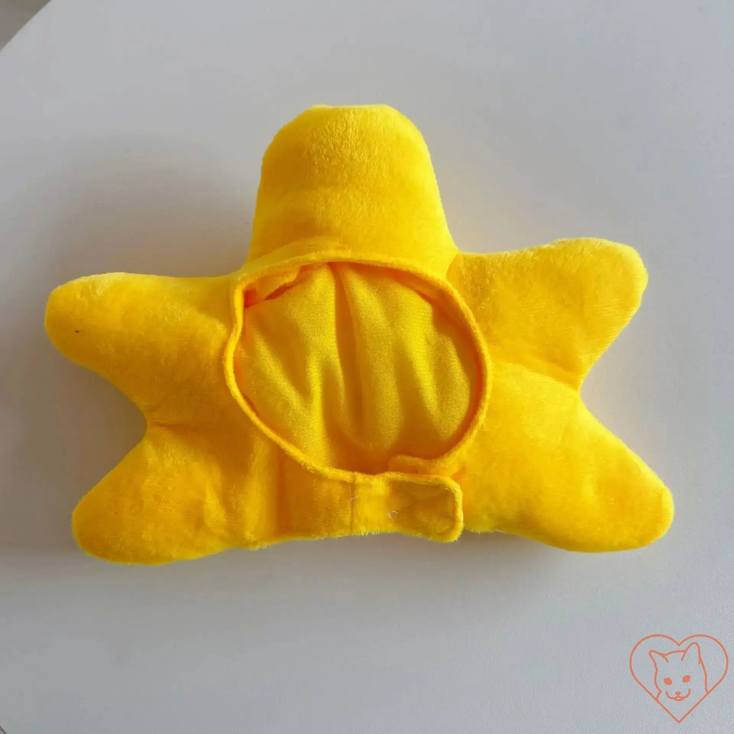 Soft yellow star-shaped plush toy with a cozy center, perfect for pets or as a decorative item.