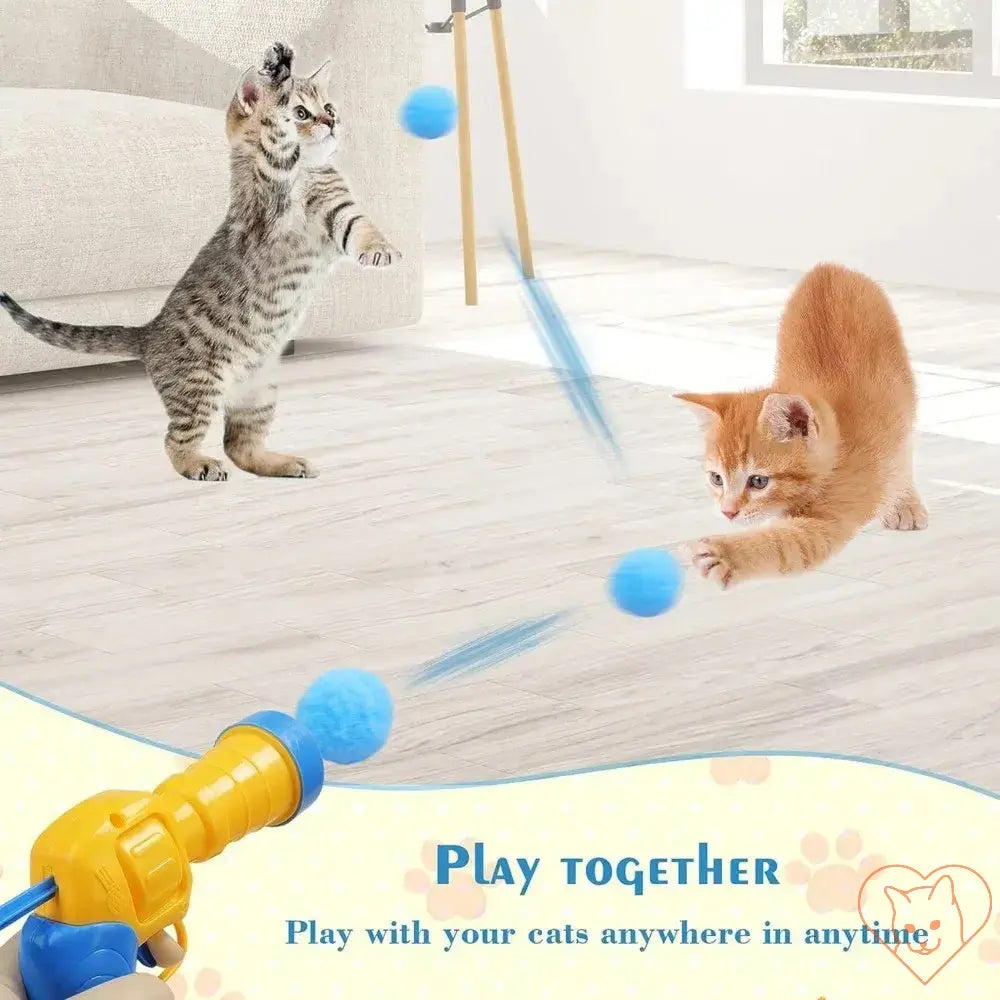 Two playful cats chasing plush balls from a cat toy gun, promoting interactive playtime and exercise.