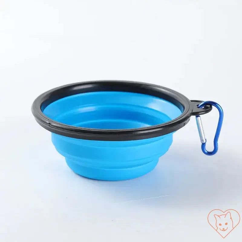 Portable folding silicone pet bowl in blue with carabiner for travel and easy pet feeding.