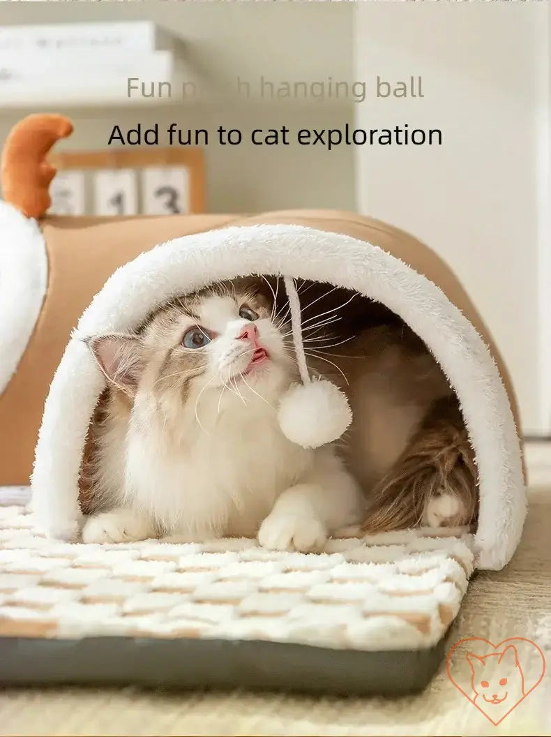 Cozy cat exploring plush tunnel with hanging ball, enhancing playful winter retreat experience.