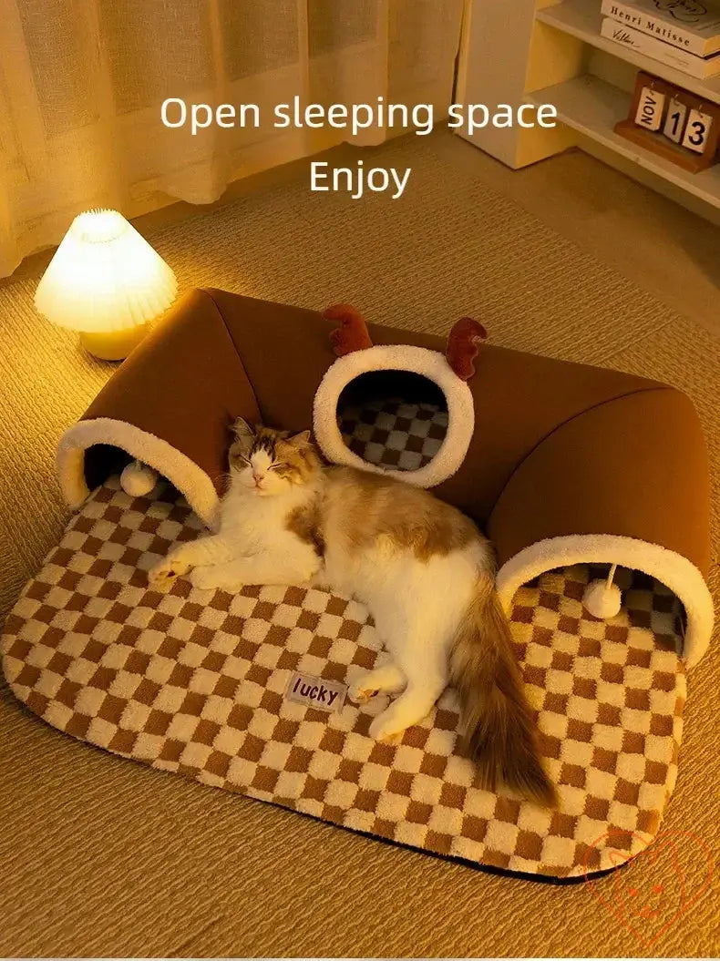 Cat enjoying cozy reindeer plush bed with open sleeping space, perfect for winter naps and playtime.