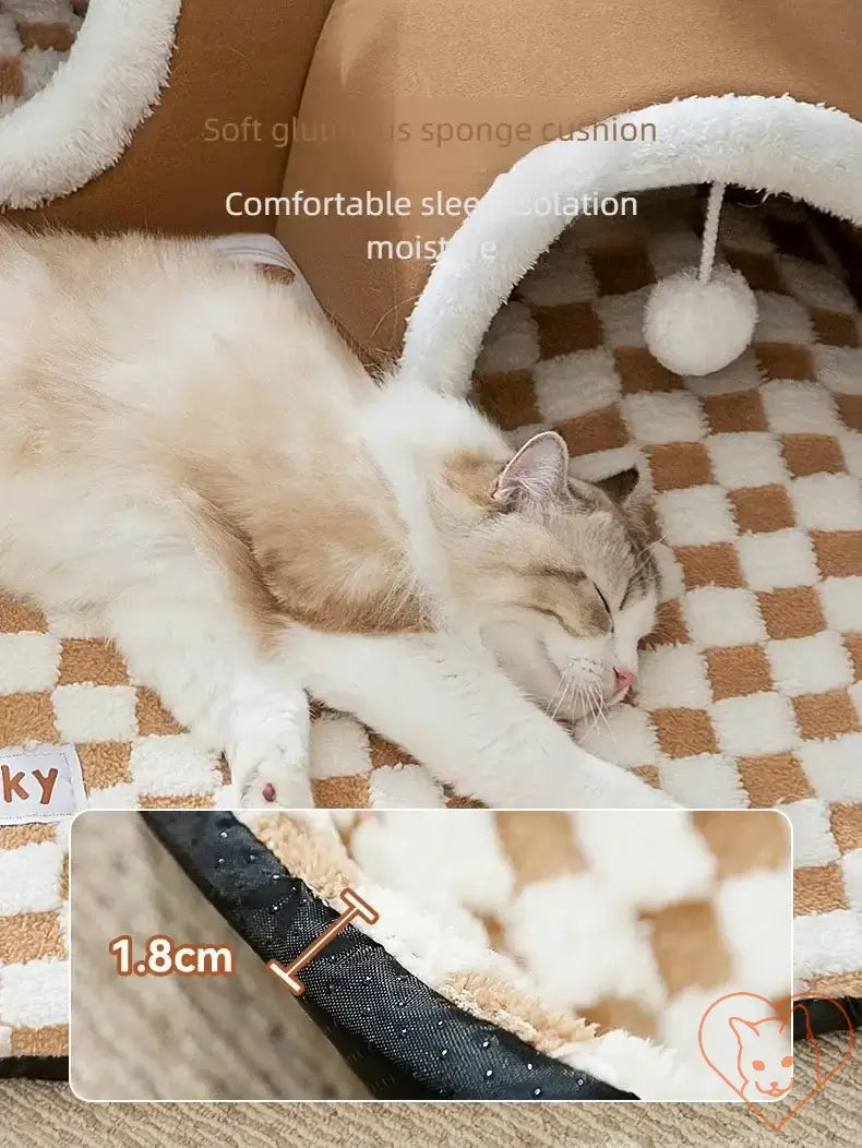 Cozy cat sleeping on a soft checkered cushion in a plush tunnel bed, showcasing comfort and warmth.