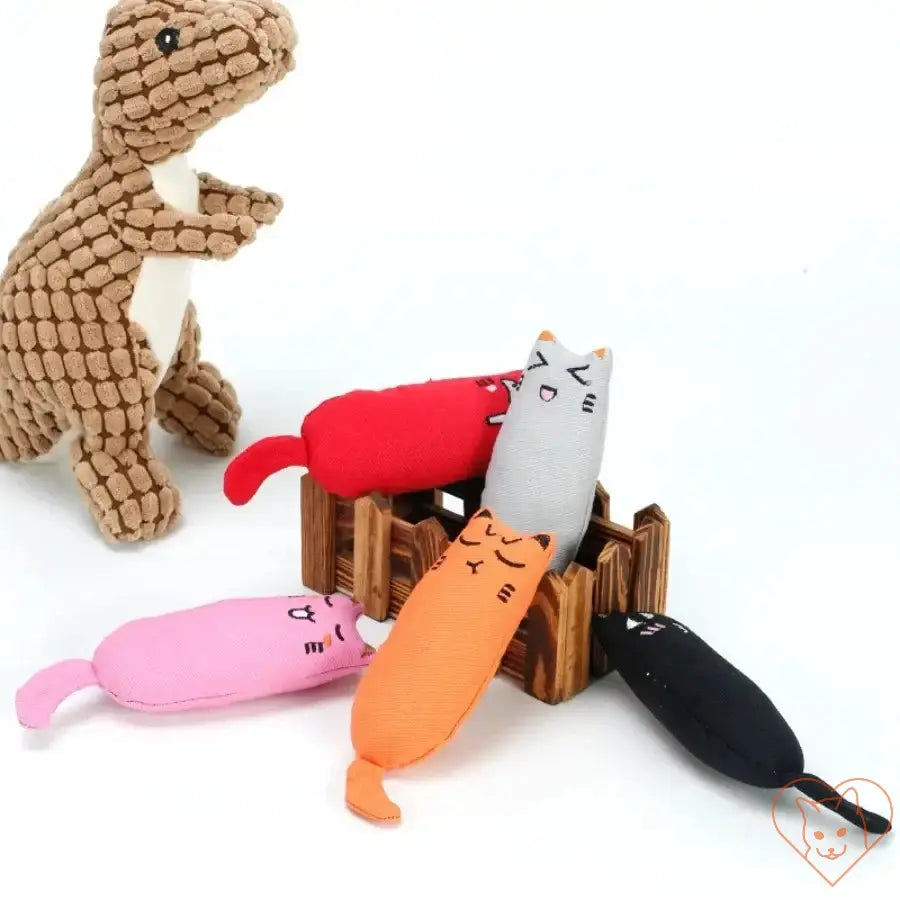 Colorful catnip plush toys in a wooden box with a dinosaur toy, perfect for cat playtime and stimulation.