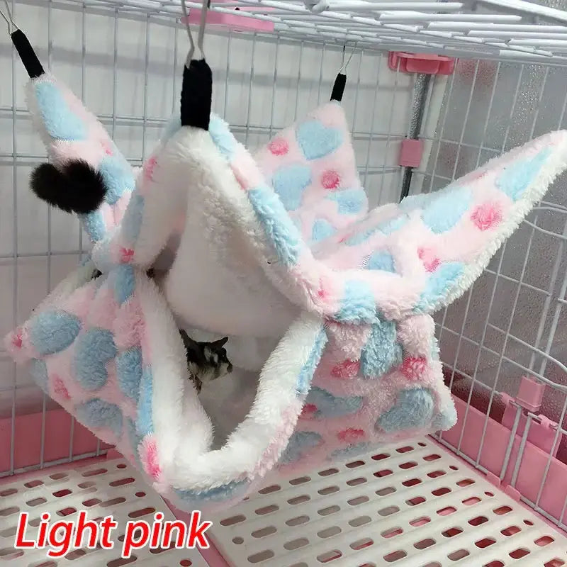 Cozy Thick Plush Hanging Tree Bed in light pink with blue polka dots, perfect for cats and small pets.