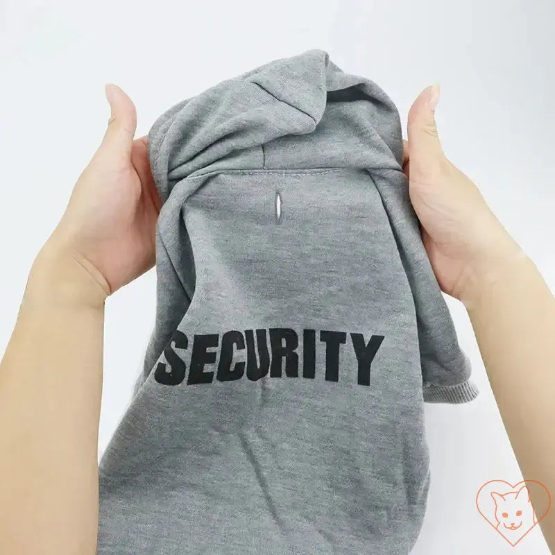 Gray Security Cat Hoodie held in hands, perfect for keeping pets cozy and stylish.